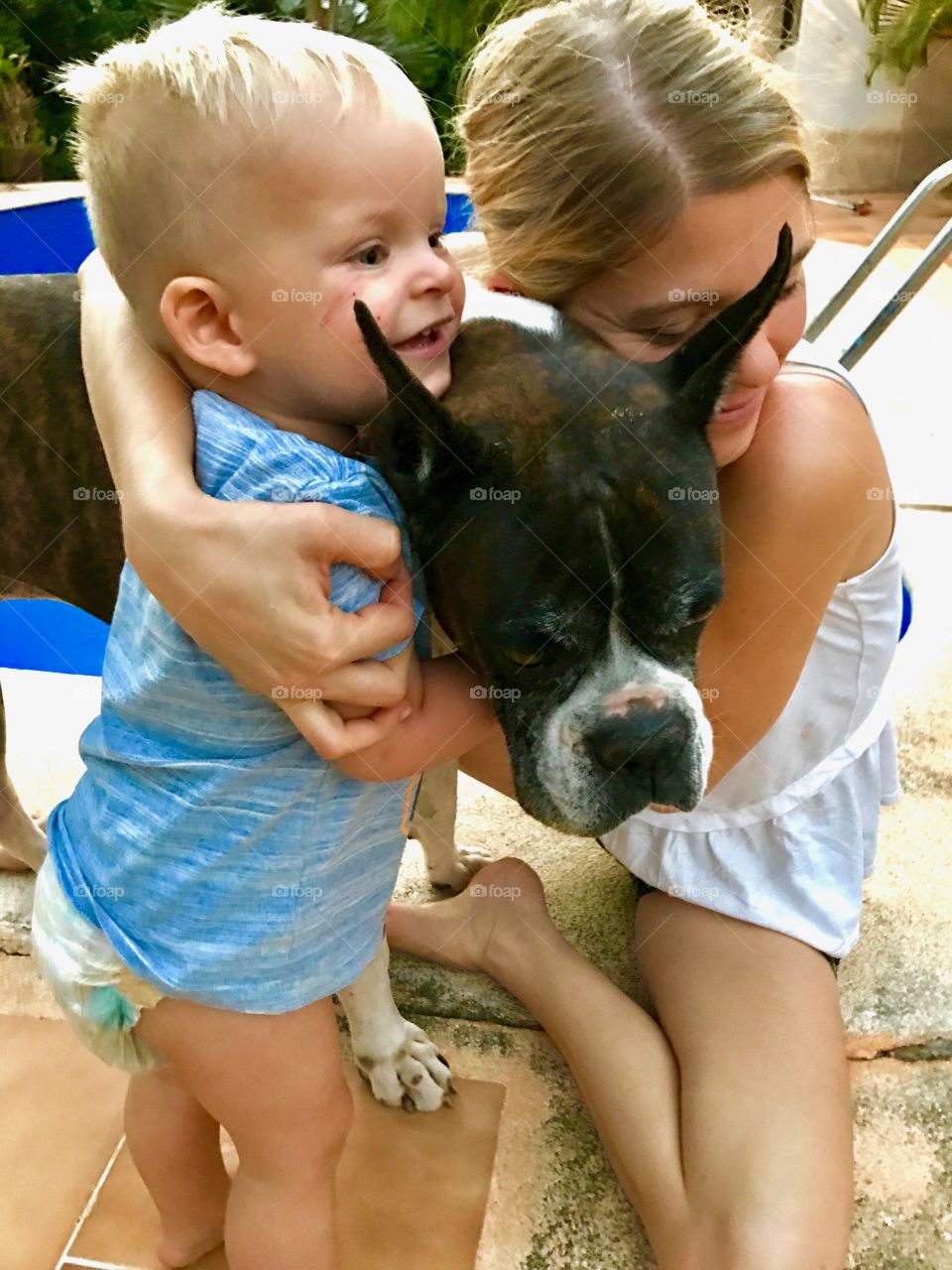 Mom and child with their boxer dog 