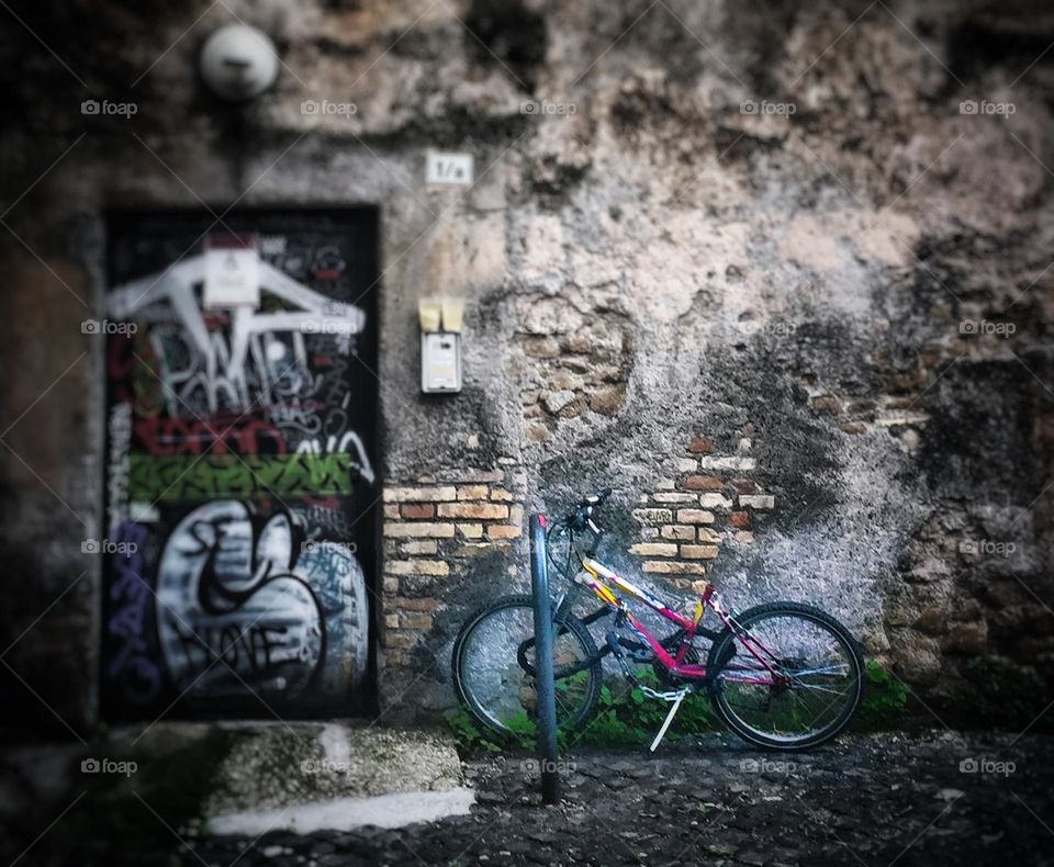 Bicycle against a wall with graffiti 