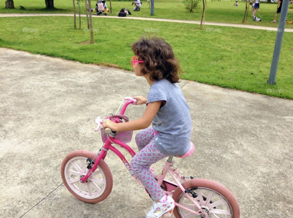 Child pedaling in the park