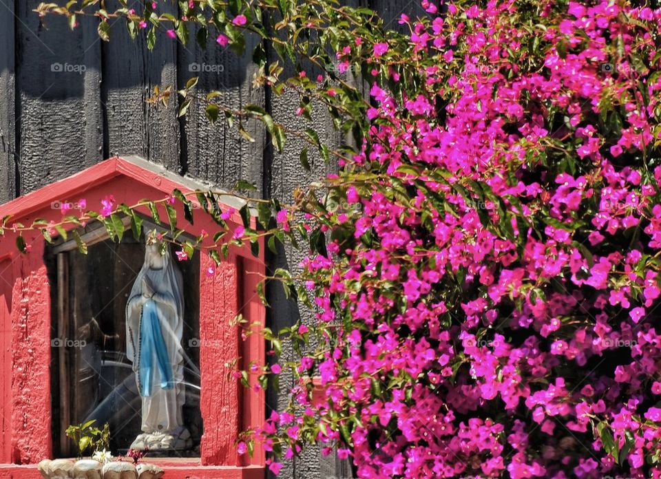 Virgin Mary Statue with Flowers