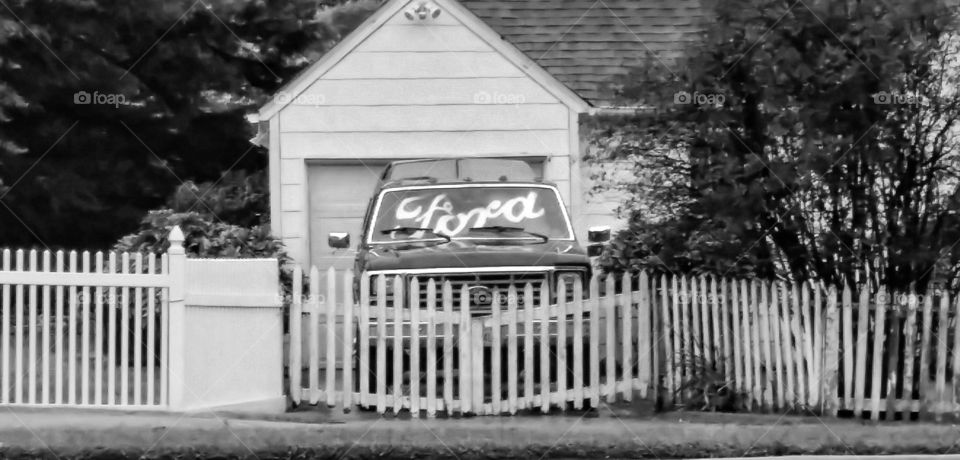 Ford behind fence. Pic from car on morning commute