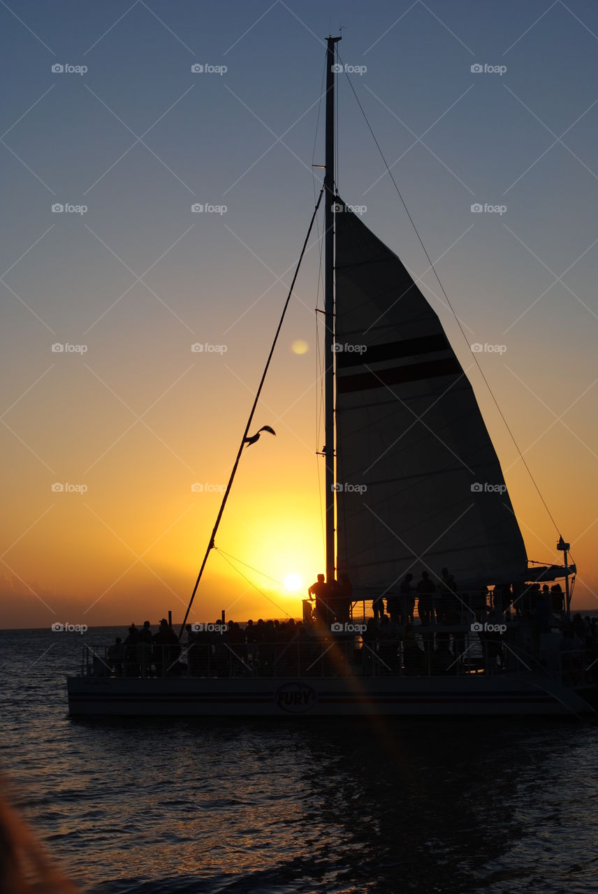 A boat sailing at sunset in Key West, Florida