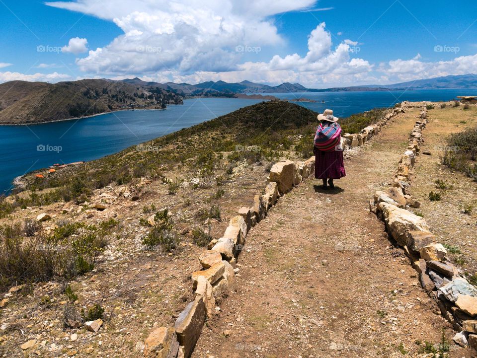 An indigenous woman walling around lake Titicaca in Peru