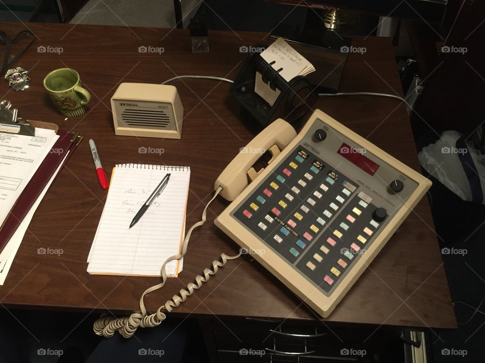 1980’s era desk with a serious phone system and roladex 