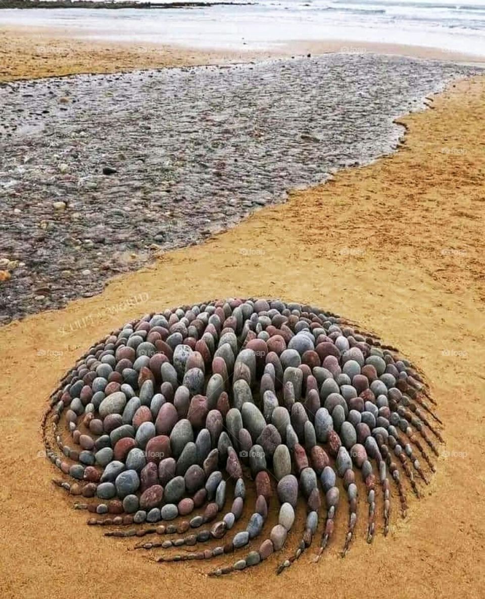 Painting with stones on the beach