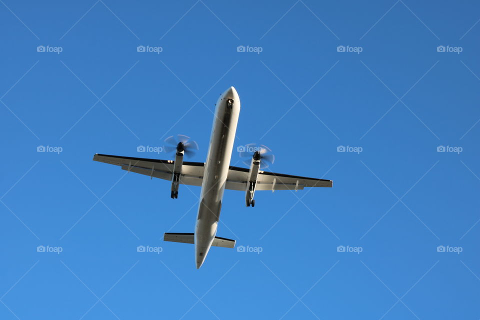 Silver plane on a blue sky