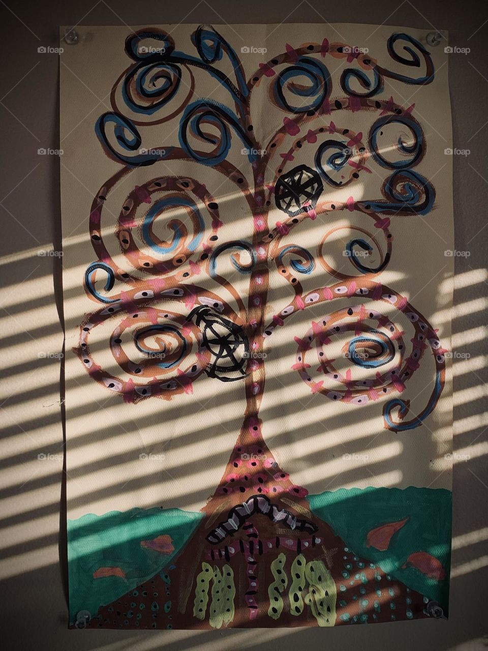 A child’s Tree art on display in their parent’s bedroom, in a spot close to the window. The blinds cast a nice shadow on the paper.