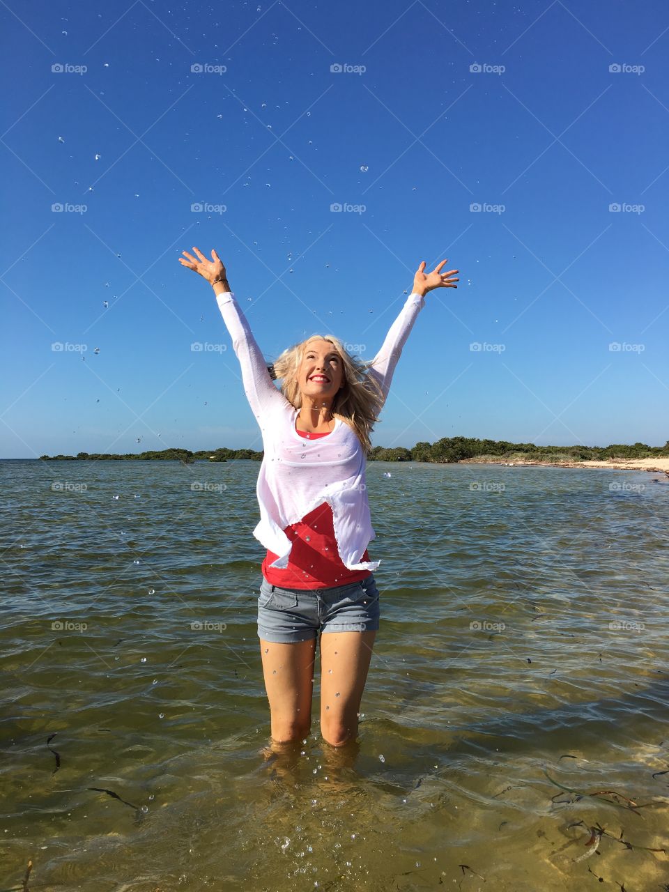 Happy woman standing in water