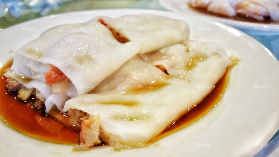 Chinese yum cha roast pork rice noodle. This is a typical Cantonese dim sum dish from Southern China, including Hong Kong.  Served as a snack or small meal.
