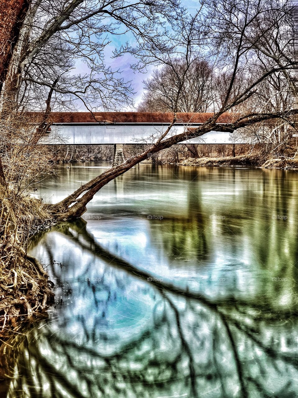Beautiful Indiana covered bridge on a winter day on the river. 