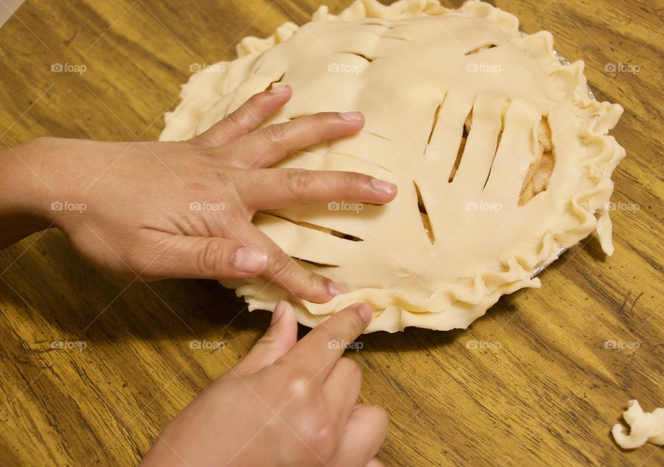 Finishing touches to an apple pie before baking 