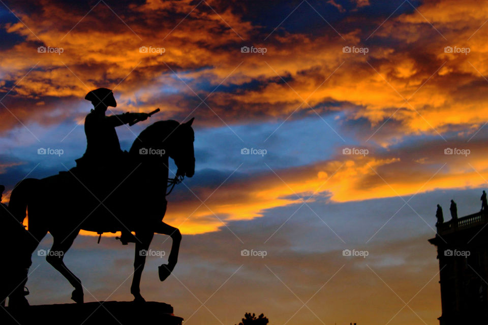 Statue of a man in a horse with message