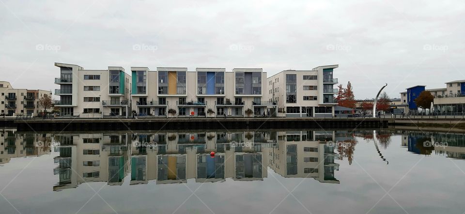 Reflection of houses on the calm water