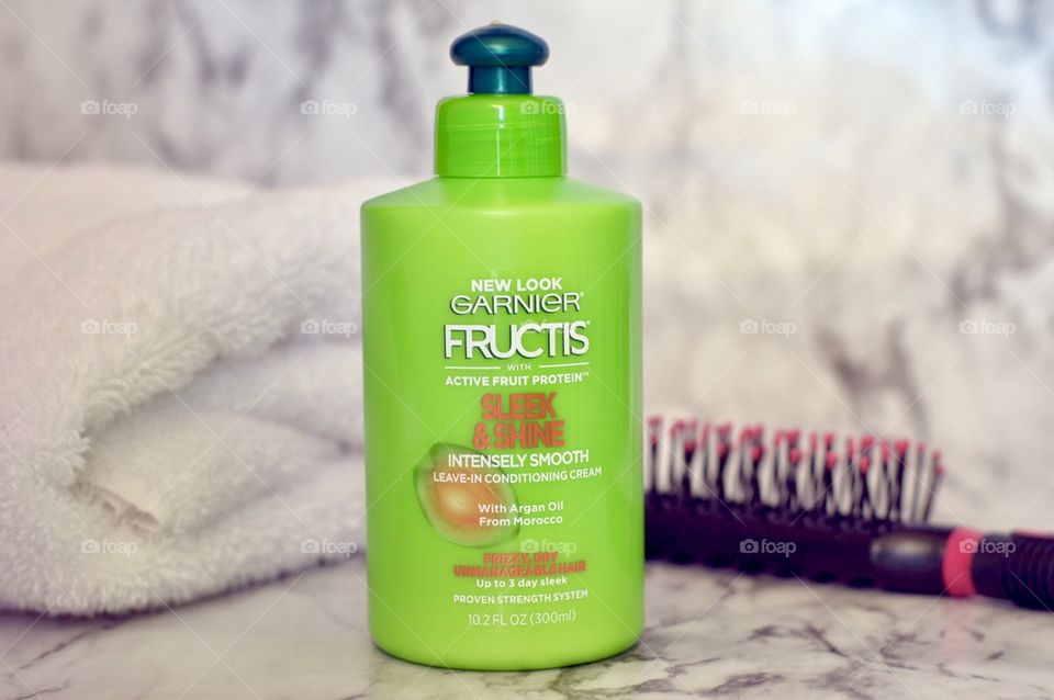 Garnier sleek and shine leave in hair conditioner on a marble background 