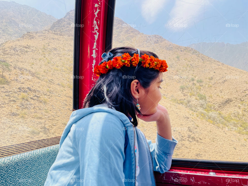 Girl enjoying the beauty of nature from cable car 