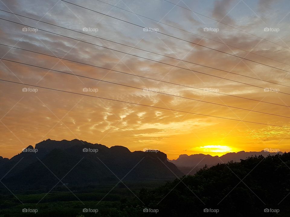 Scenic view of mountain range against sunset sky