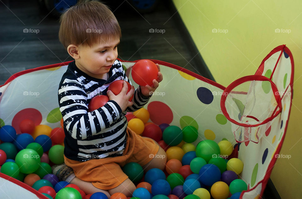 boy playing with colorful balls