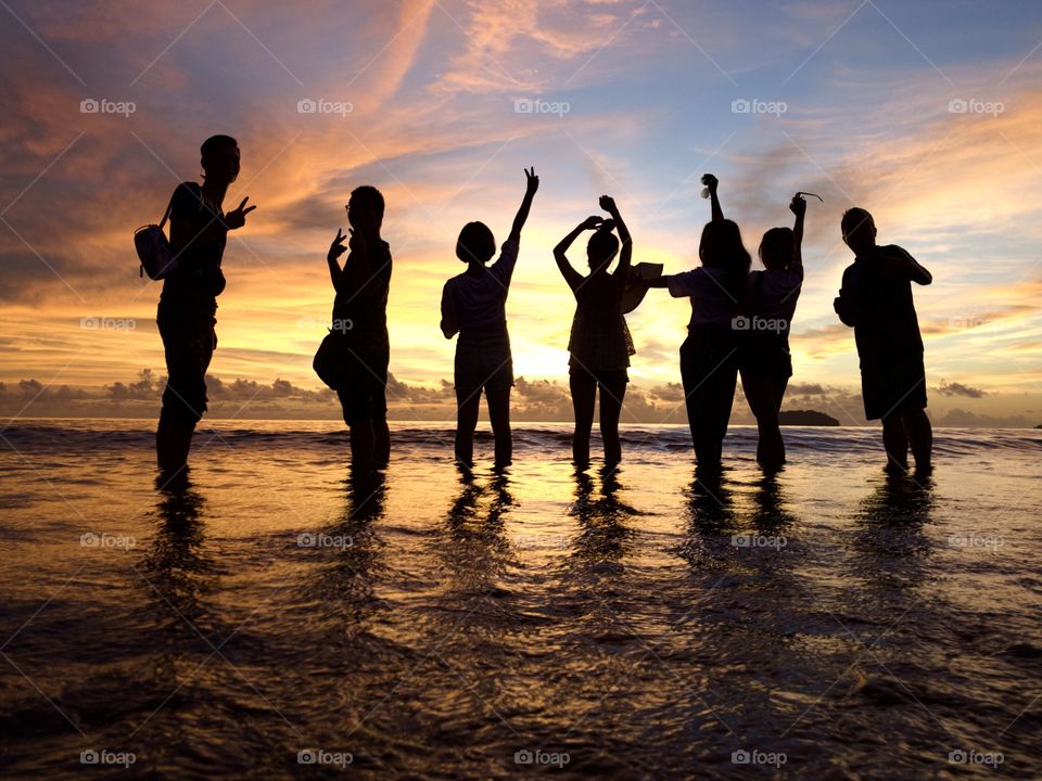 Good bye day, group of mainland China tourist in the Tanjung Aru beach during sunset scene 