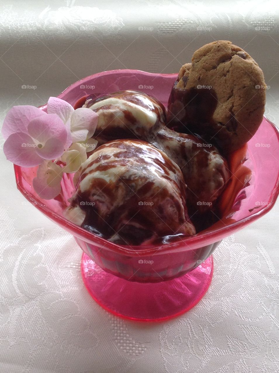 Vanilla ice cream with chocolate syrup drizzled on top.