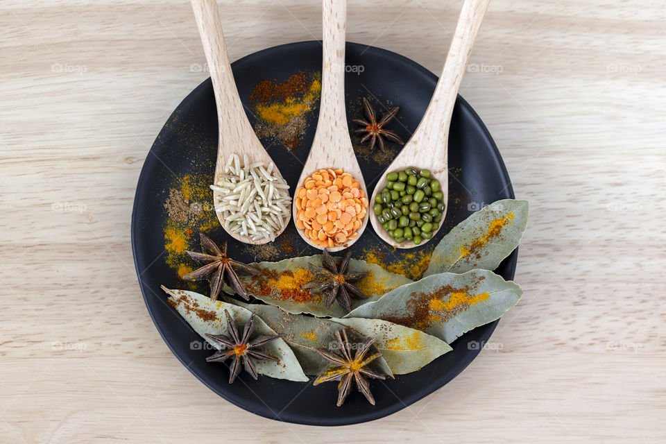 Flatlay from above. Different grains on the plate with various spices.