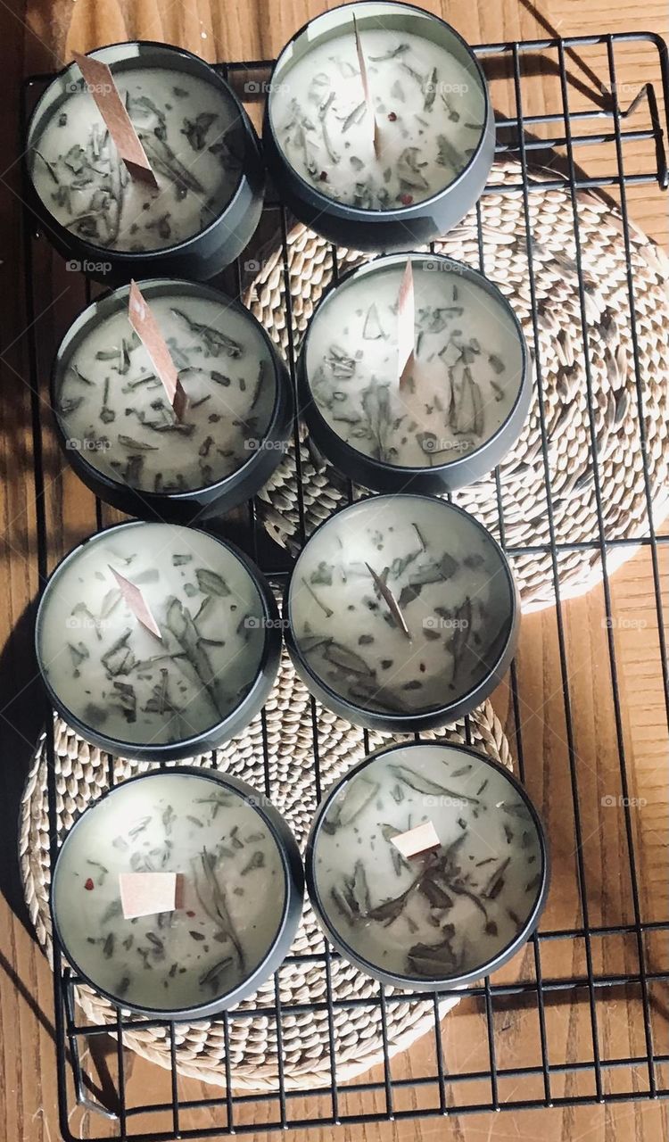 Candles in the making, sunlight, dried sage, wood wicks
