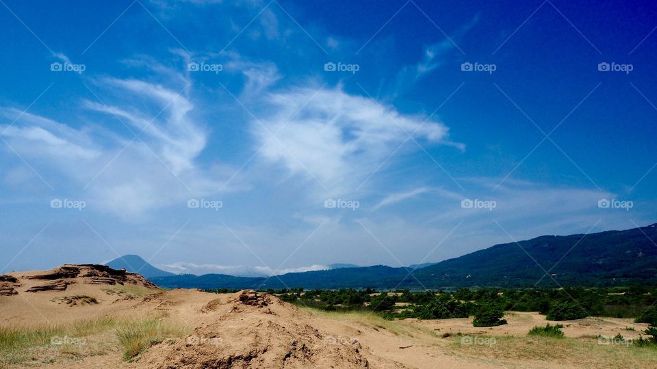 Issos beach sand dunes, lake korrission and mountains in the distance, Corfu, Greece