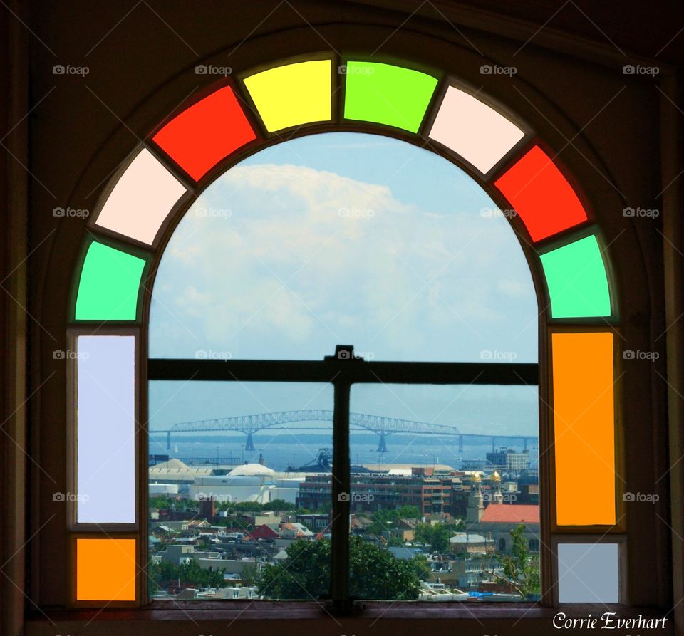 The Key. photo taken through stained glass window from inside the Pagoda in Patterson Park. Baltimore Maryland showing the Key bridge in the distance. 