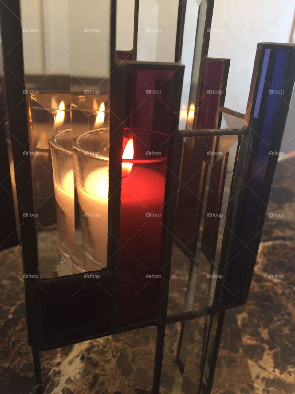 Tri color transparent candle holder on kitchen table 