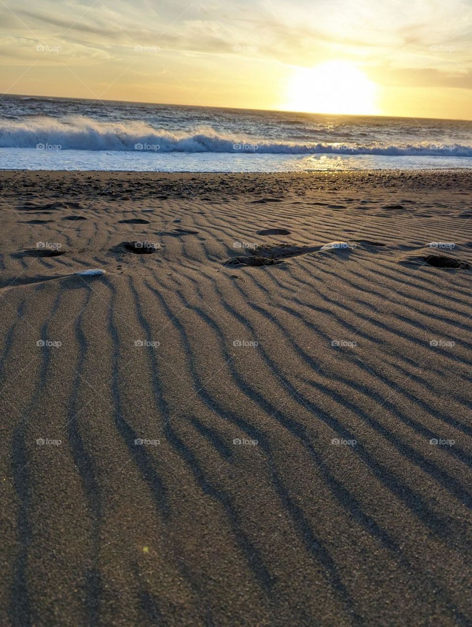 waves in the sand at a beach sunset rocks in the beach wavy lines and ocean waves sunset vibes lines in the sand