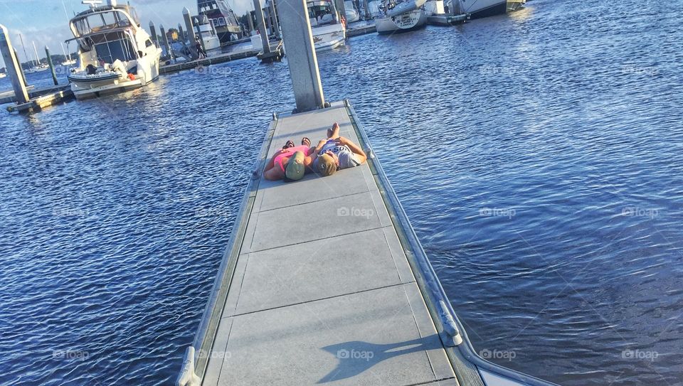 Date on a dock. A couple relaxing on a dock. 