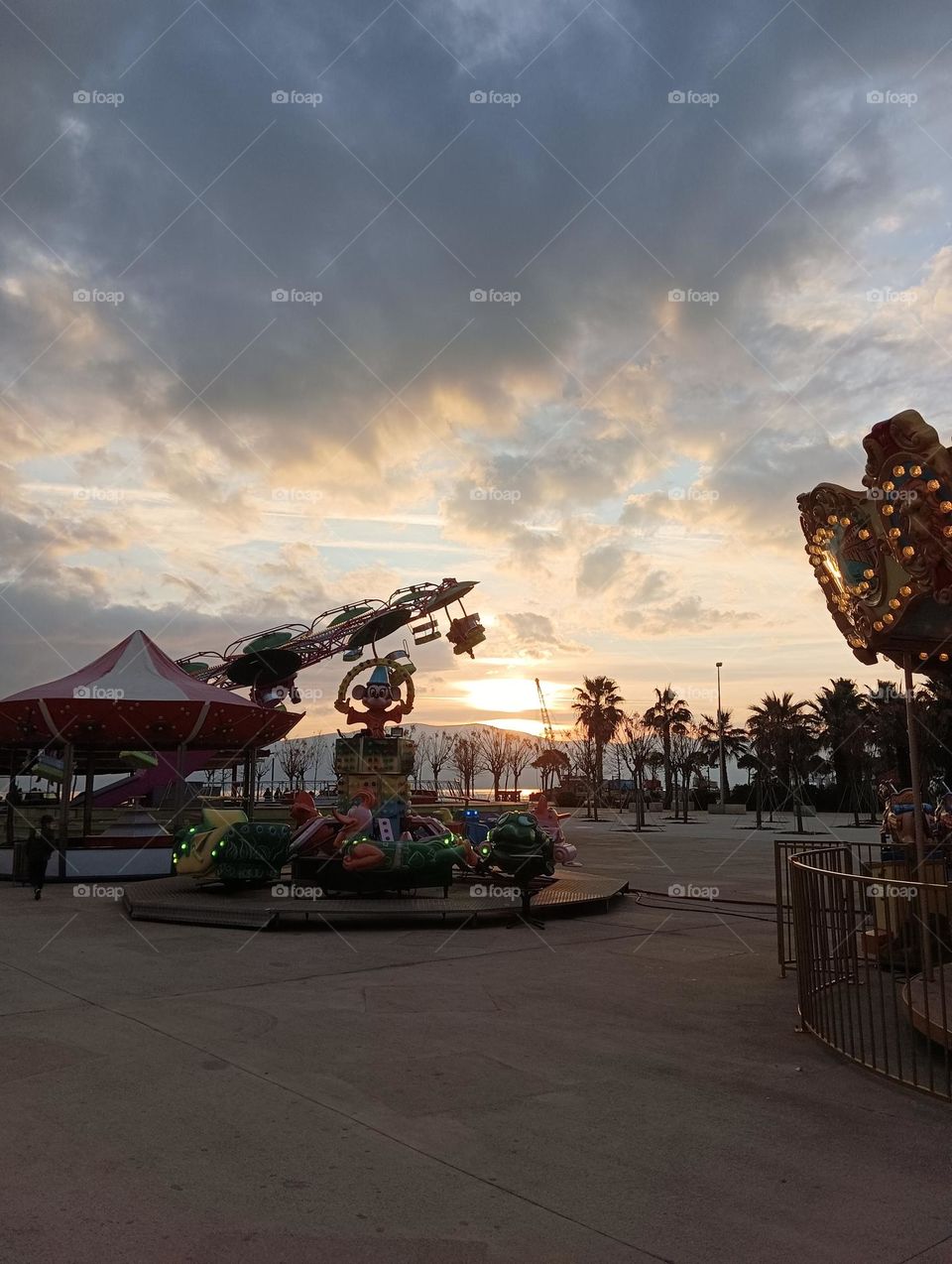 Children's rides against the backdrop of the sunset sky