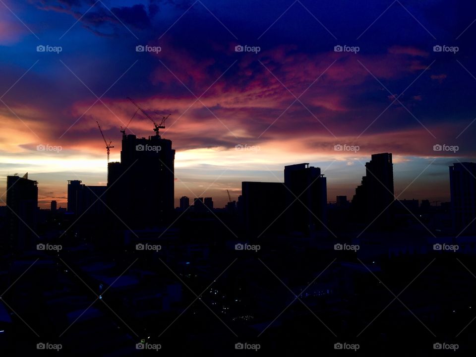 A dramatic Bangkok sunset skyline as a storm threatens to end the peace 