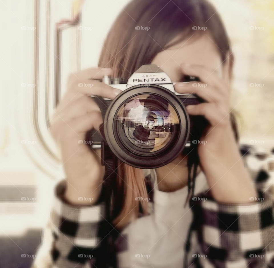 a fabulous picture of a young girl taking a photo