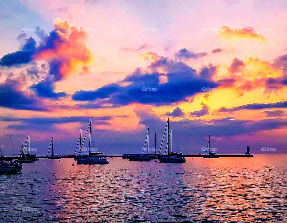 beautiful sunset with boats in foreground