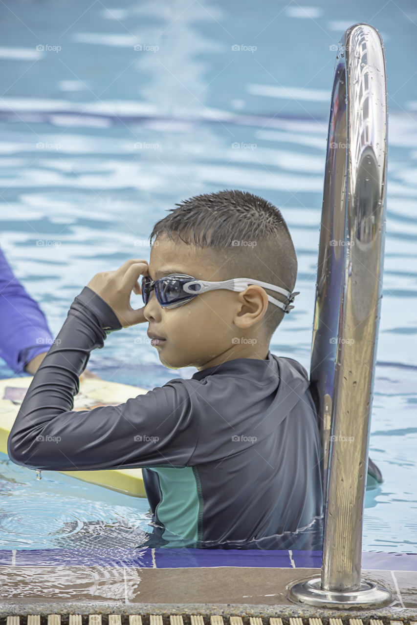 Asean boys are swimming in the pool.