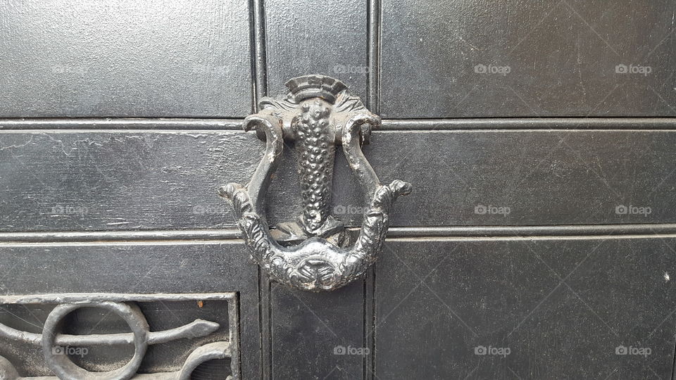 an imposing black door knocker