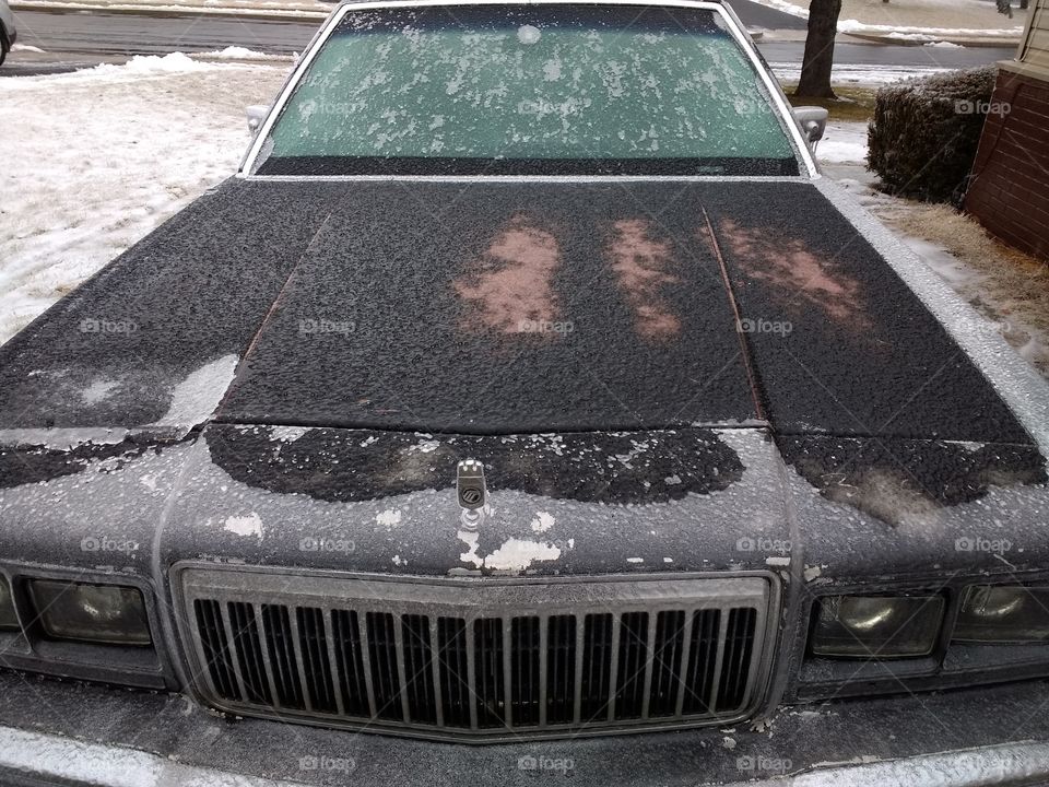 a cold day
driving atthe camera in a big classic car