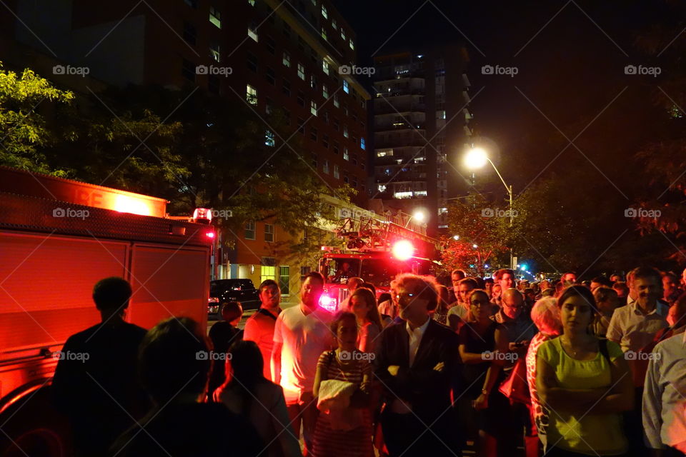 Chaos in the city. Fire trucks and people scattering in panic