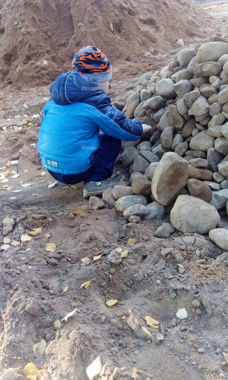 boy play with rocks