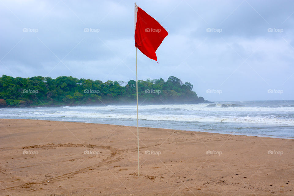 The beach flag. This photo was clicked by me during my visit to south goa during the summers . It was calm and secluded beach 