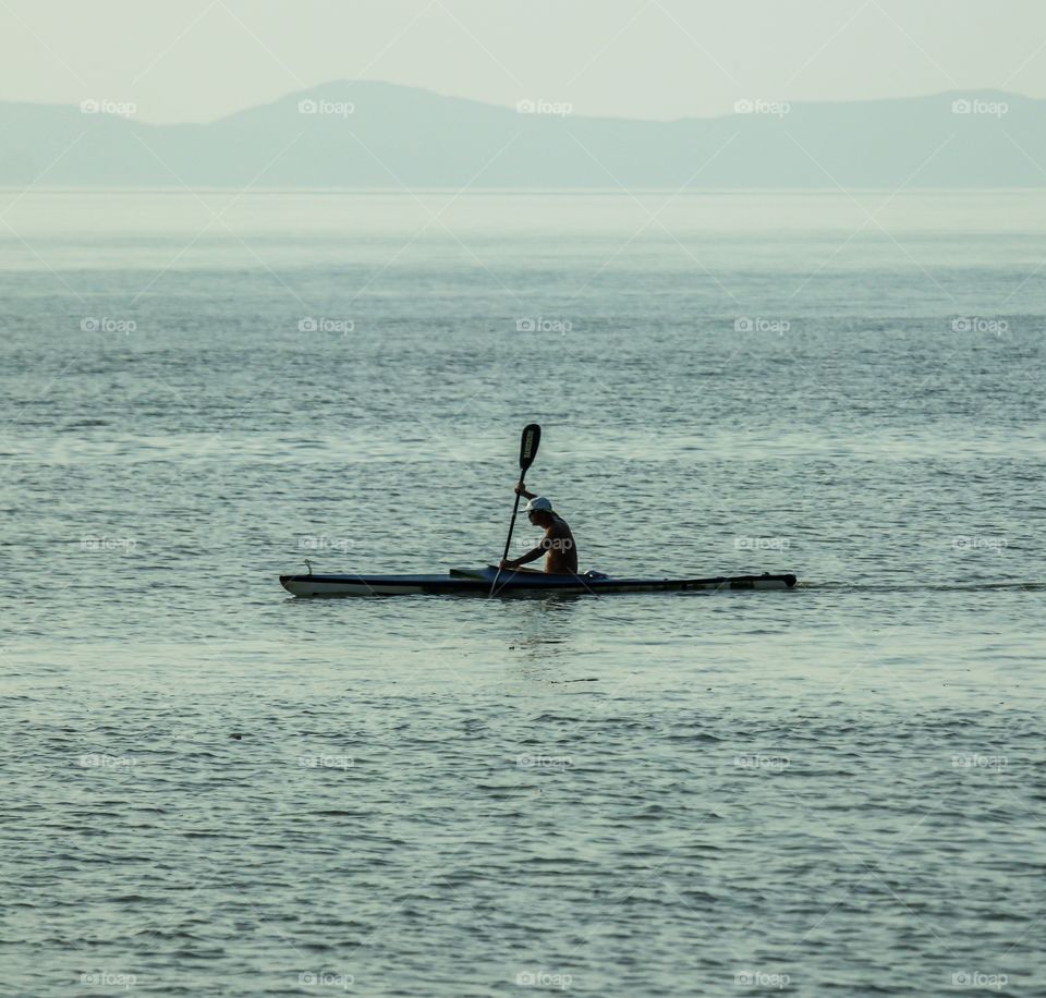 Canoeing alone at the coast of Macau, Water Sports Human Interest.