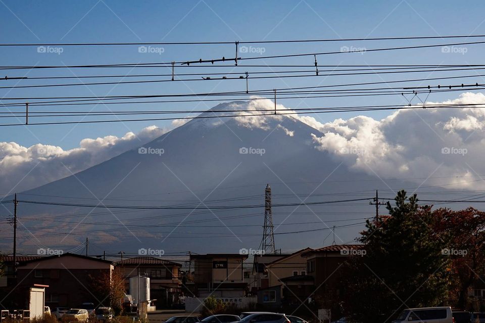 Clouds fly around the summit of Mt. Fuji on an autumn day. Photo taken from Kawaguchiko, Japan.