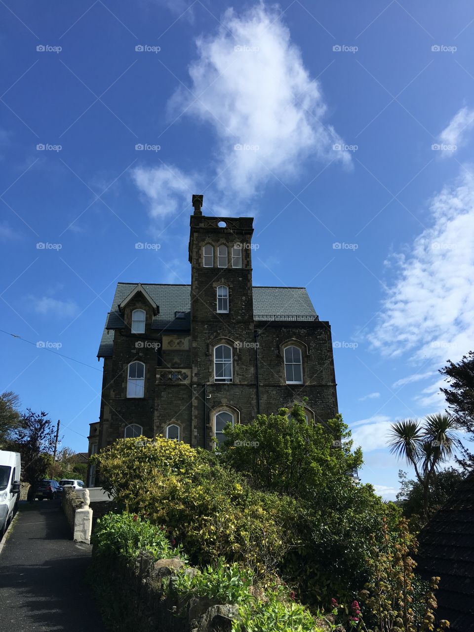 Merlin Court in Ilfracombe under a gorgeous spring sky in North Devon. Clouds, foliage and perspective in this photo 