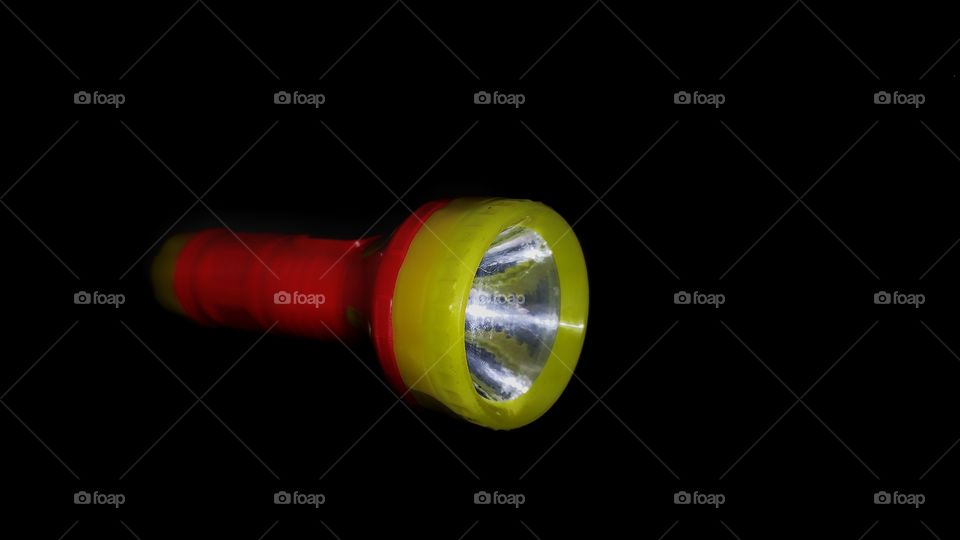 orange yellow coloured beautiful small torch in dark black background.