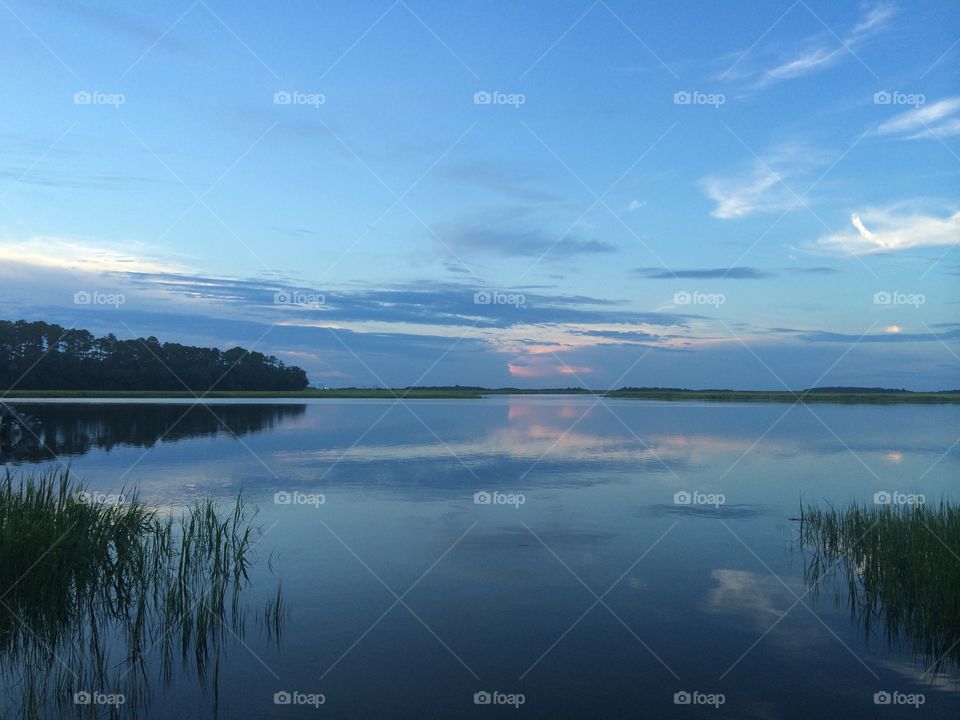 Blue dusk over a calm, reflective lake. 