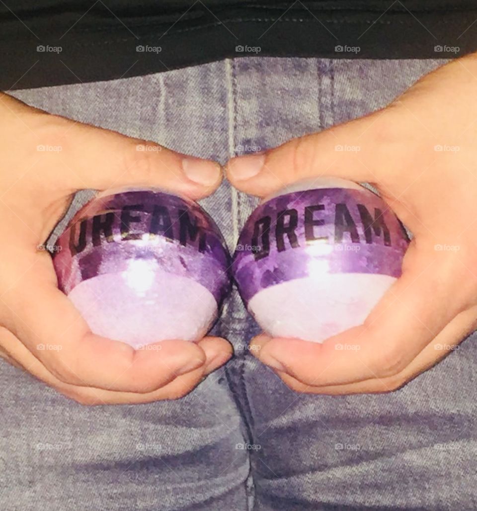 Holding two DREAM bath fizzers from Victoria’s Secret, implying one should grab their dreams ‘by the balls’. Wearing grey jeans and black T. Spring.