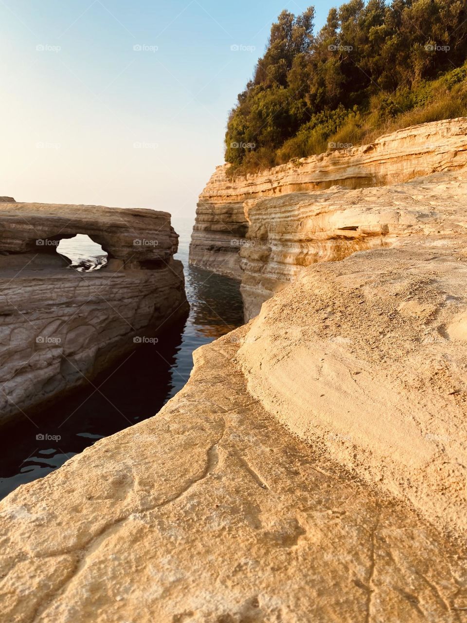 A winding channel opening into the sea, creating a natural pathway between land and water.