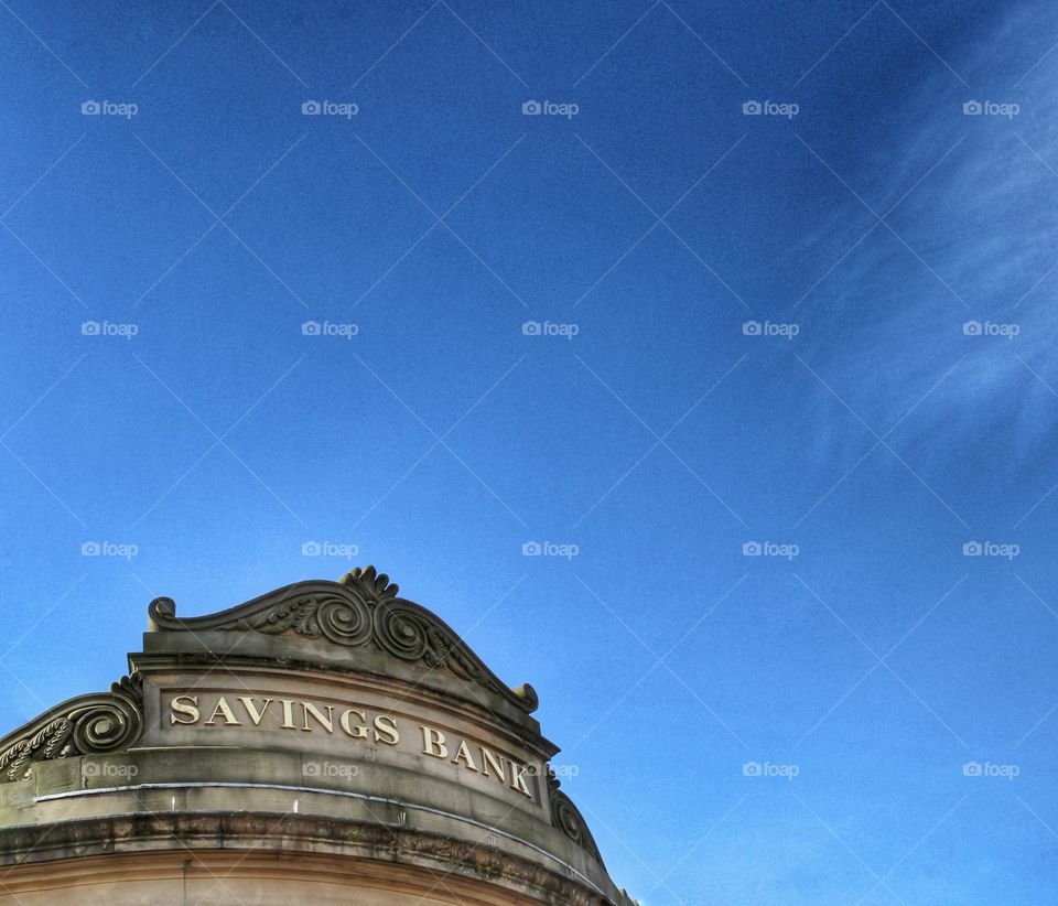 A savings bank sign on the outside of a financial bank.