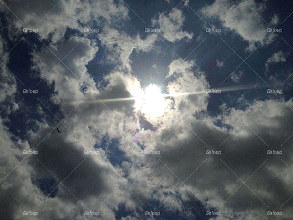 Sun peaking through the clouds at the beach 