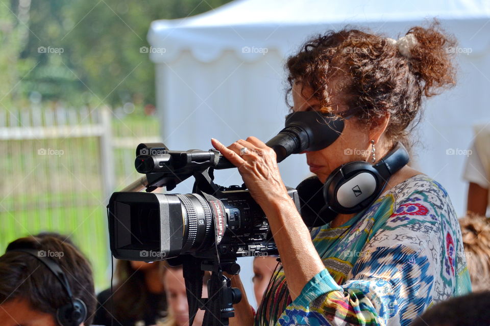 a woman makes shooting with a professional camera